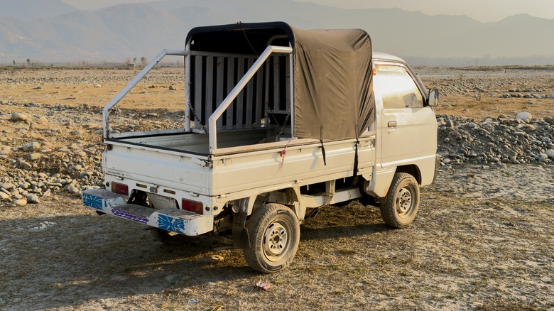 Side view of a Suzuki Carry kei truck in Swat, Pakistan.