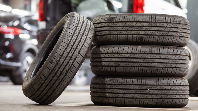A stack of tires in a mechanic's shop.