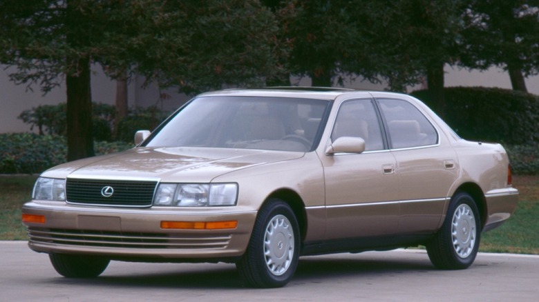 1990 Lexus LS400 parked on paved surface with trees in the background