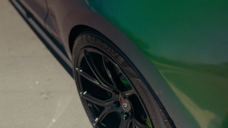 The inscription on the Lionhart LH-Five tires, mounted on a colorfully wrapped Ford Mustang, close-up