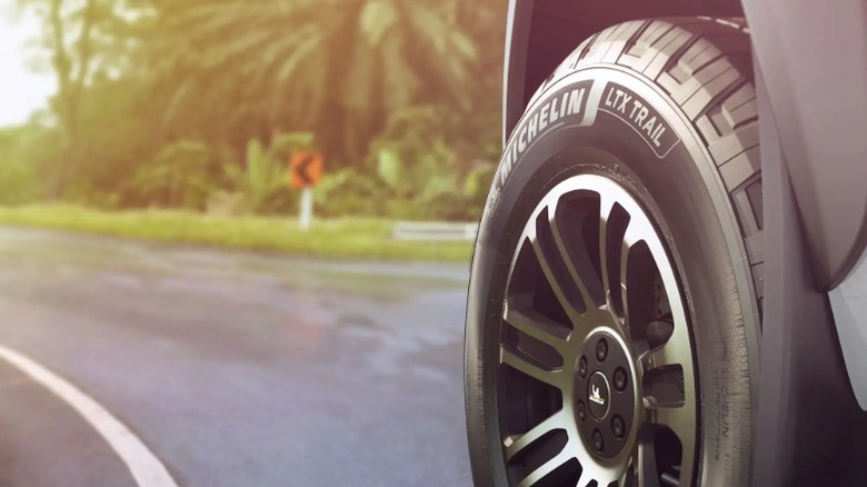 Close-up of a Michelin LTX Trail tire driving on a wet roadway
