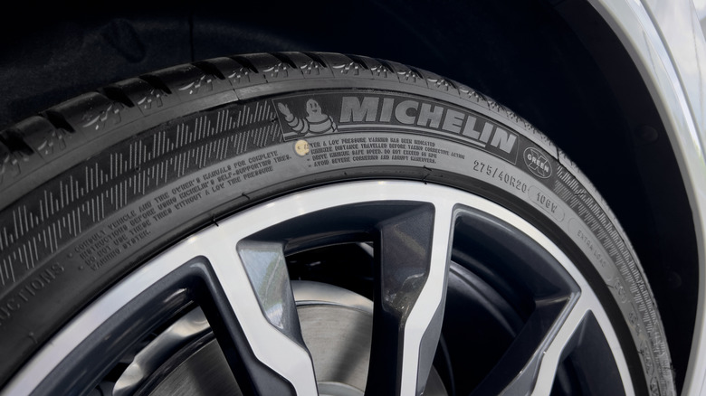 A close-up of the logo on a Michelin tire mounted on an unidentified vehicle