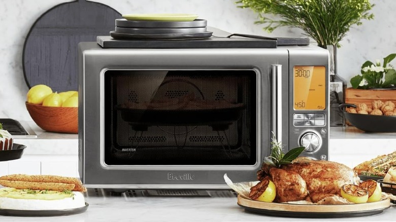 A Breville combination microwave surrounded by food.