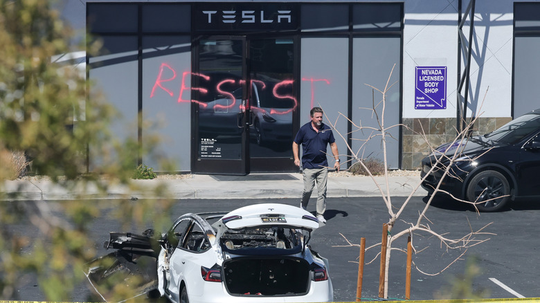 Investigator at defaced Tesla dealership