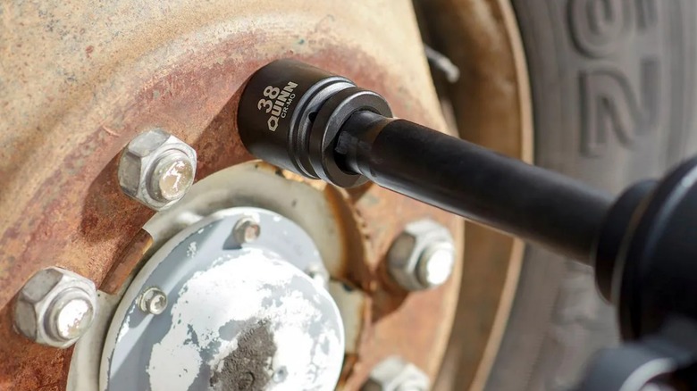 a quinn impact socket attached to an extension being used to remove lug nuts