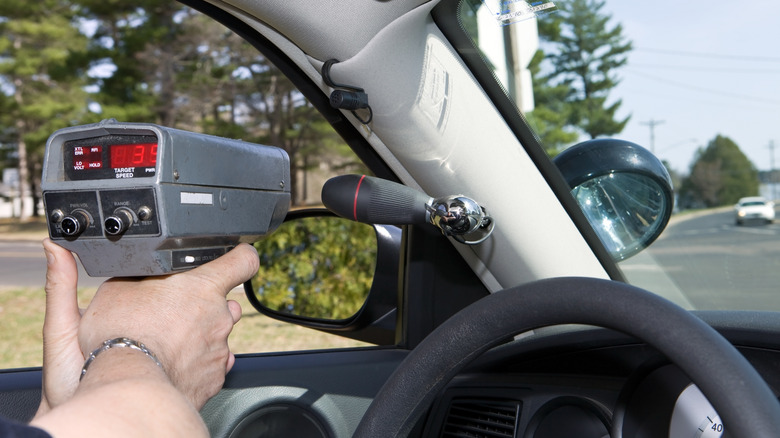 police officer using speed gun