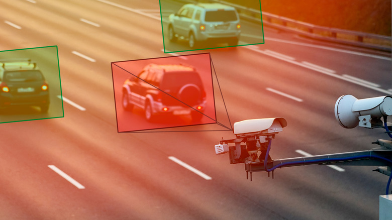 Speed camera tracking three vehicles, two with green square overlay and one with red square overlay