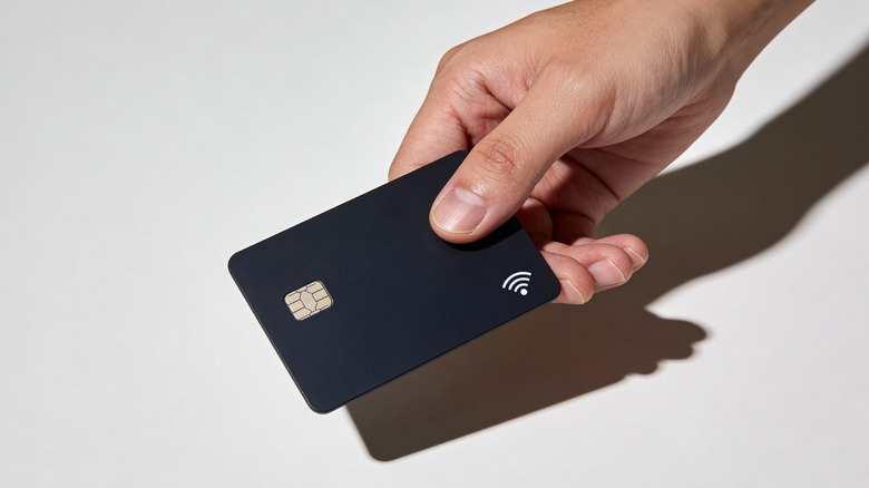 Person holding a card with contactless payment
