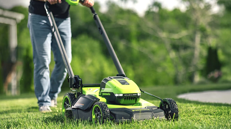 Person using Greenworks lawn mower