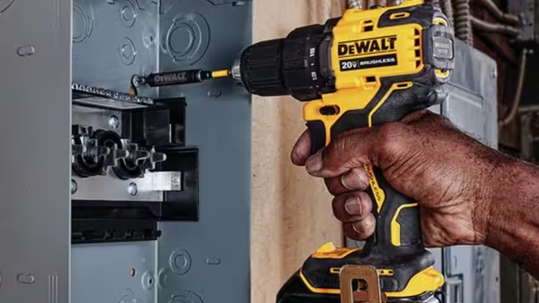 A person using a DeWalt 20V MAX cordless drill