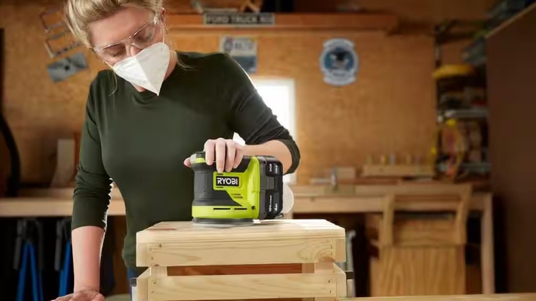 Woman using the Ryobi Random Orbit sander