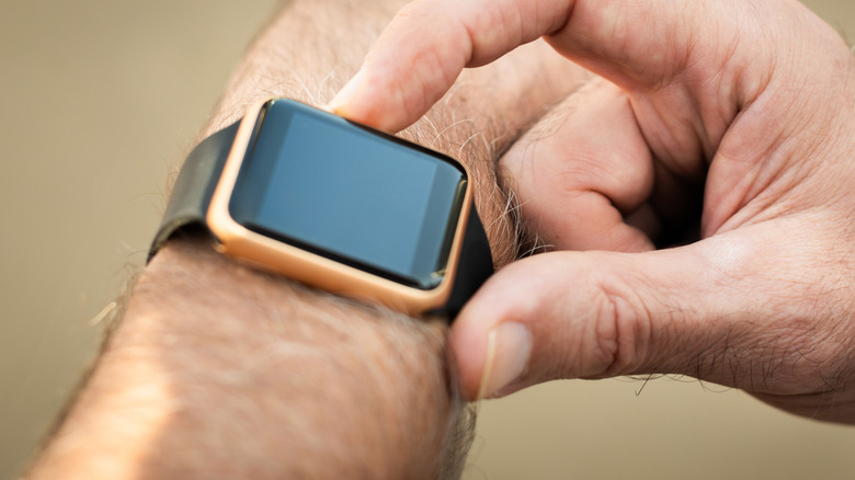 Close up of a man using a smartwatch