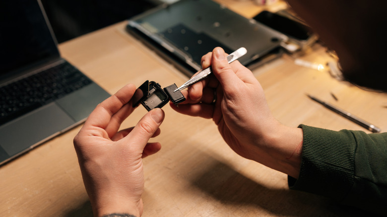 A Technician replacing a smartwatch battery