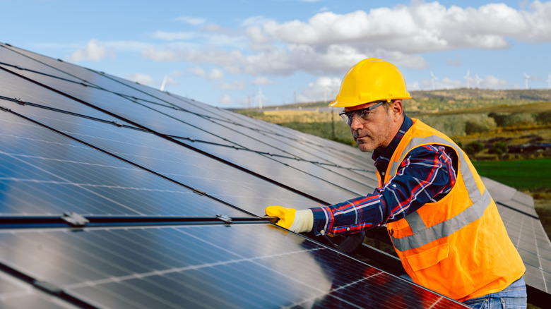 Man adjusting solar panels