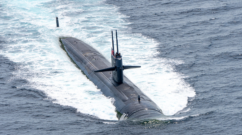 A U.S. Navy submarine cruising on the ocean surface.