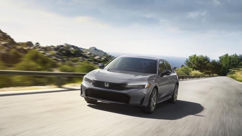 2025 Honda Civic In Gray Driving On A Mountain Road