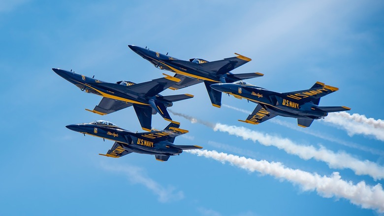 Four Blue Angels planes flying in close formation
