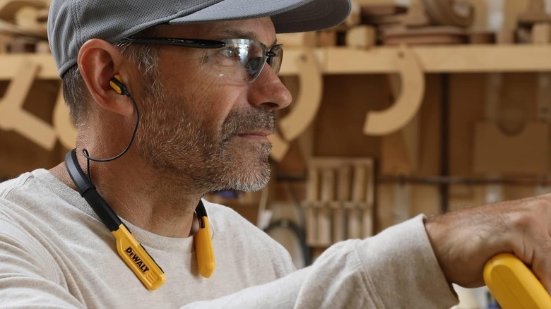 man wearing DeWalt earbuds