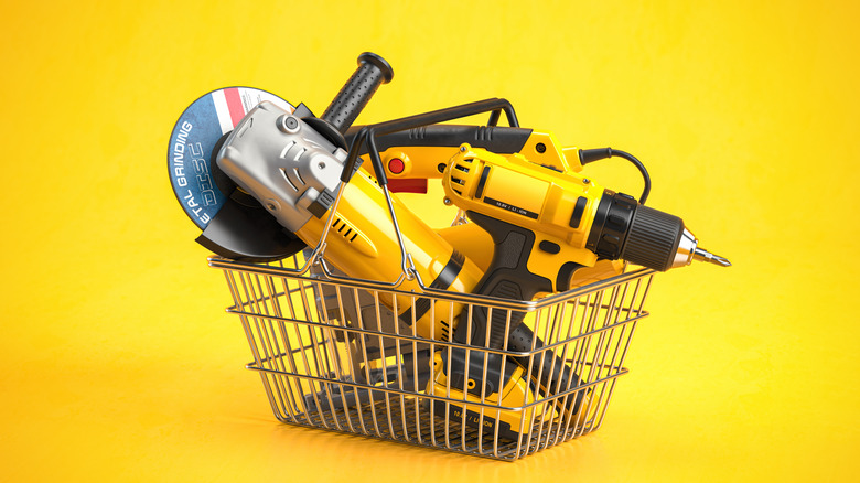 Power tools sit in a basket with a yellow background