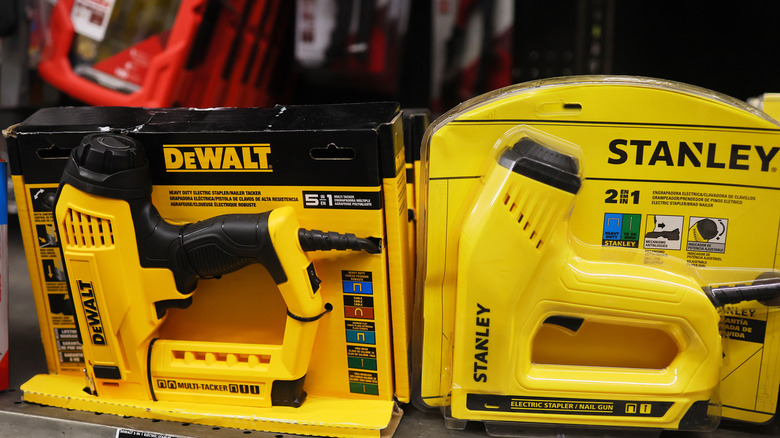 Dewalt and Stanley power tools side-by-side on the shelf