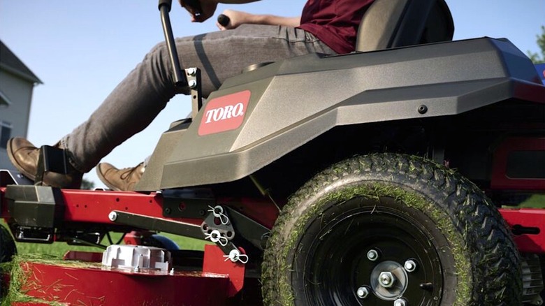 Person riding Toro lawn mower