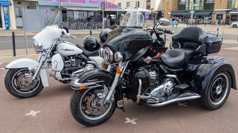 Two Harley-Davidson Tri Glide Ultras parked on a street