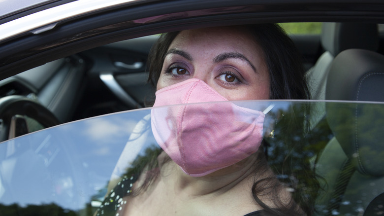 Woman behind rolled-down car window