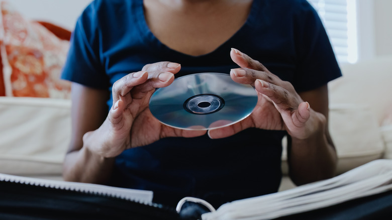 A girl selecting a CD from her collection.