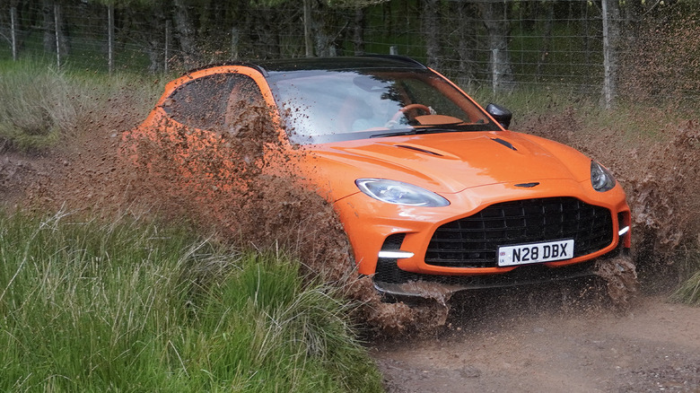 2025 Aston Martin DBX 707 splashing through mud in Scotland