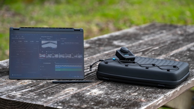 The ASUS GoPro laptop on a picnic table with accessories.