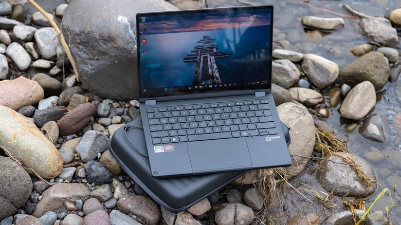 The ASUS GoPro laptop by the shore of a river.