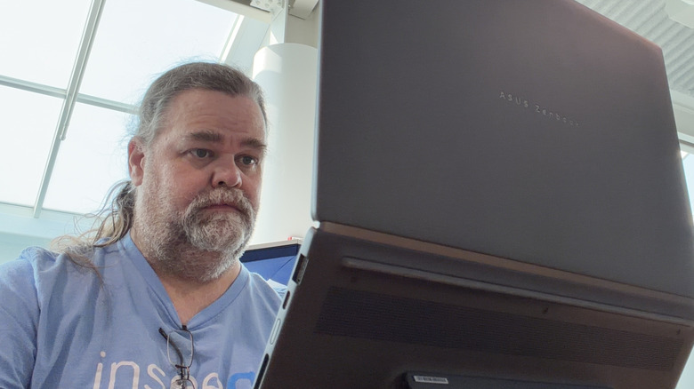 man working on the Asus Zenbook Duo