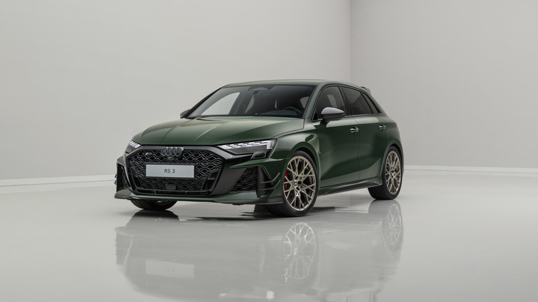 The Audi RS 3 Sportback competition limited in dark green, front 3/4 view, studio shot