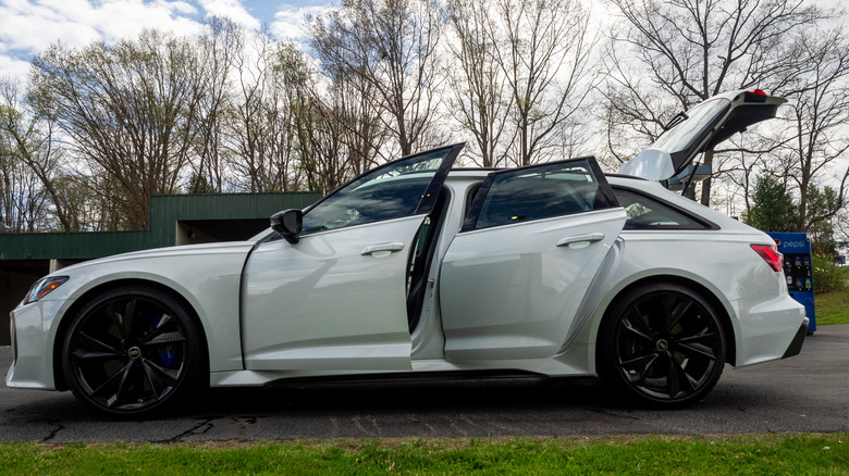 2026 Audi RS 6 Avant left profile view with doors and rear hatch open