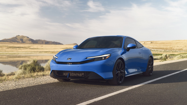 A blue 2026 Honda Prelude on a dessert road
