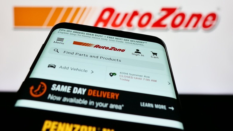 AutoZone mobile store displayed in front of AutoZone sign