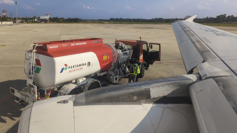 Plane fueling up on runway