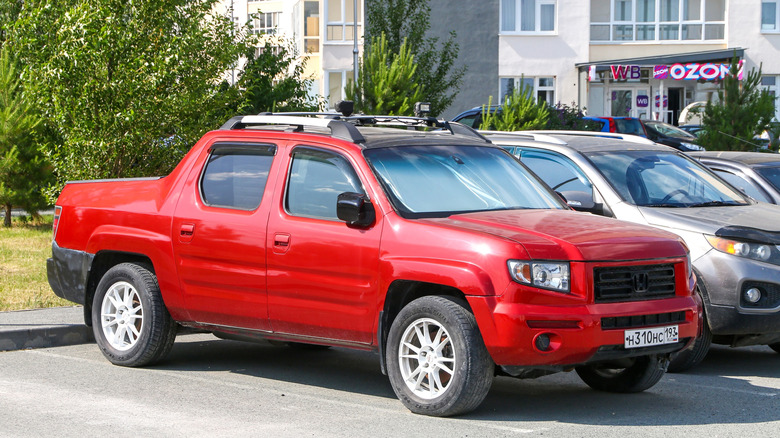First-generation red Honda Ridgeline in a parking lot