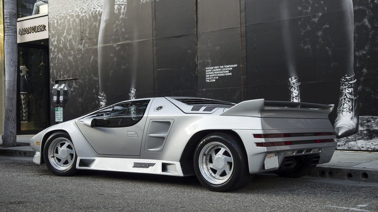 Silver Vector W8 parked on a street in front of a retail outlet