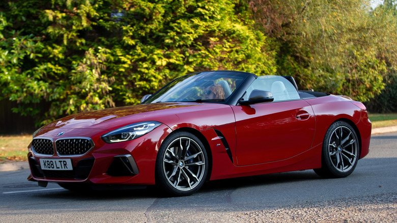A red BMW Z4 roadster parked with its roof down.