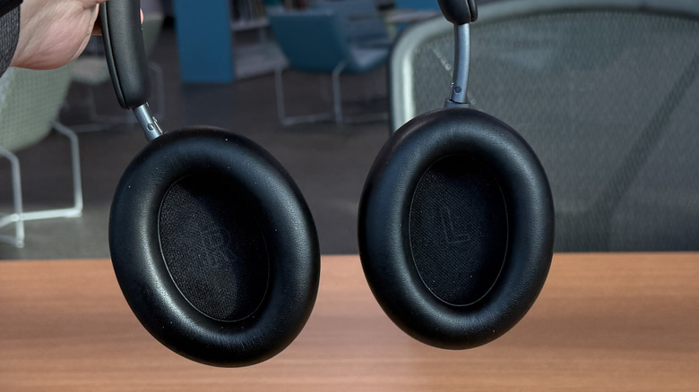 Man holding Baseus Inspire XH1 headphones