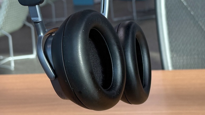Man holding Baseus Inspire XH1 headphones