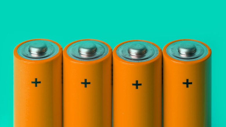 A picture of 4 AA batteries against a teal background