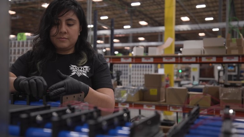 A worker in the Battle Born factory assembling a battery.
