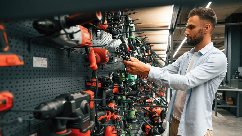 Man looking at tools in hardware store