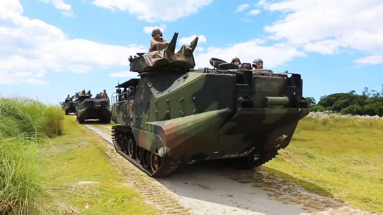 Amphibious Assault Vehicle AAVP-7A1 riding on dirt road with blue skies