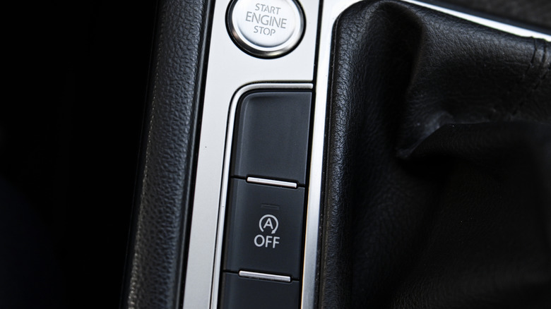 The auto-start stop off button in the center console on what appears to be a Volkswagen
