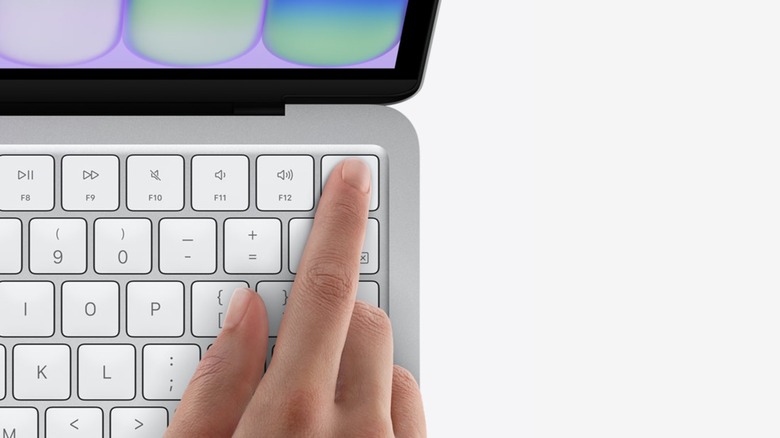 a person using TouchID on a 512 GB Apple MacBook Neo