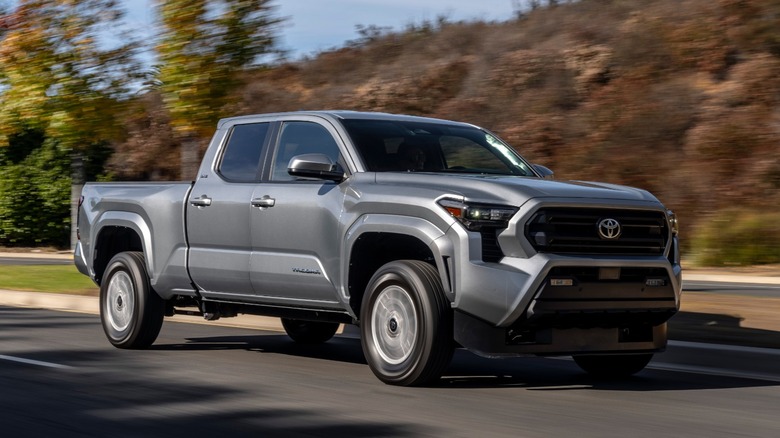 Silver Toyota Tacoma driving on a rural road