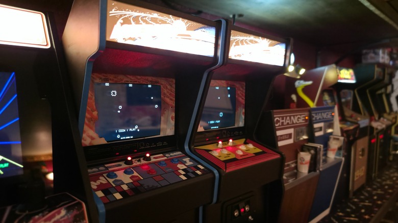 Several New Wave Toys mini arcade cabinets turned on and working